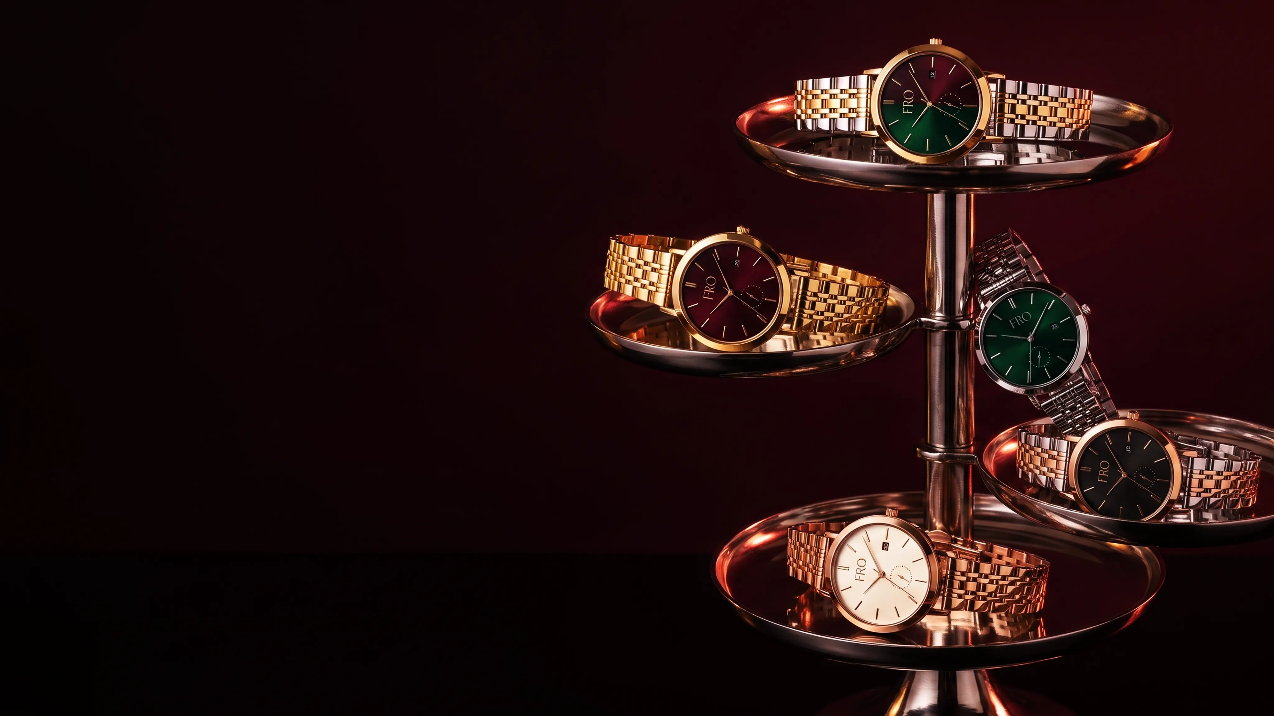 Five Dualle watches on a copper tiered stand