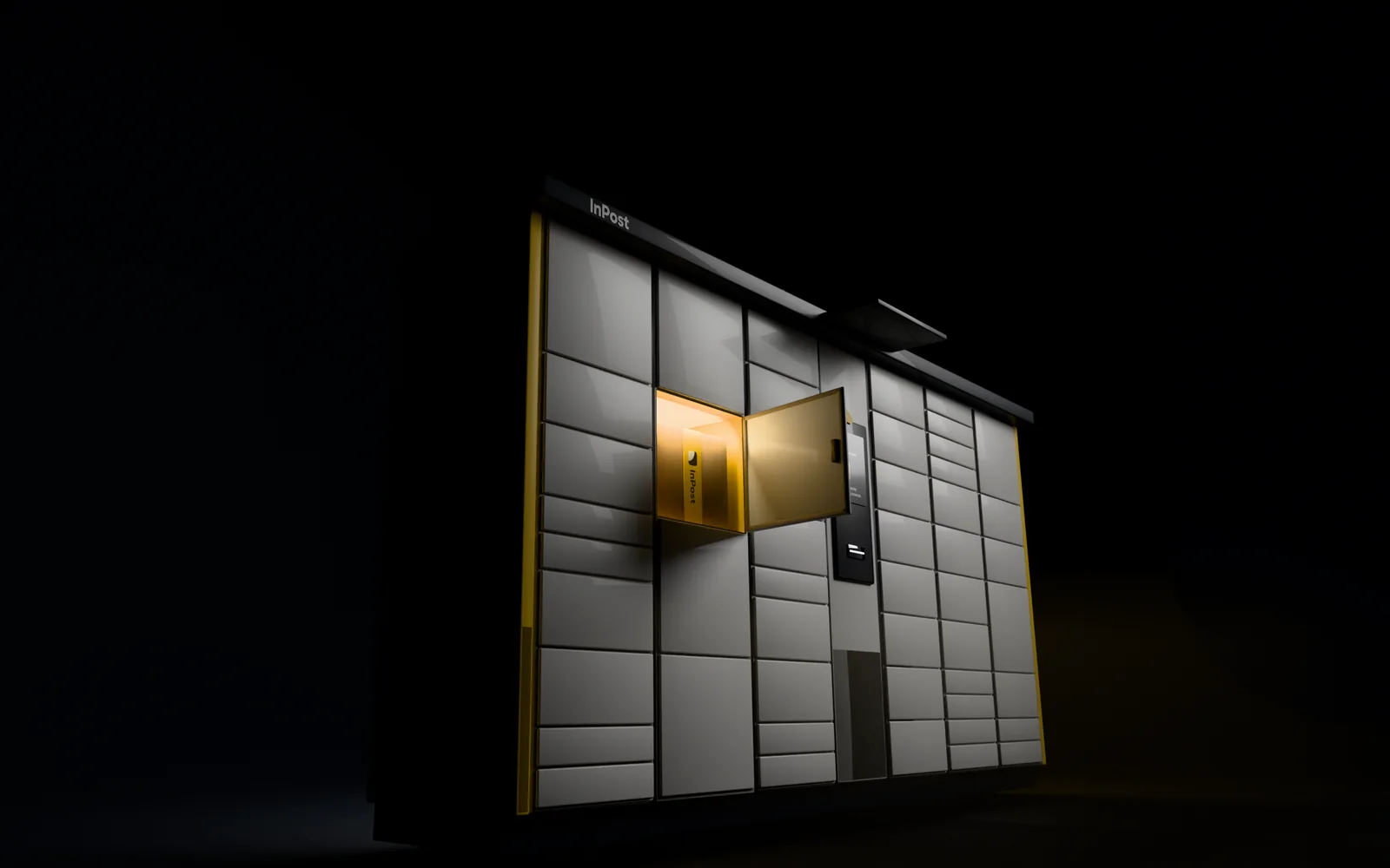 A wall of InPost parcel lockers at night, one cell open and lit
