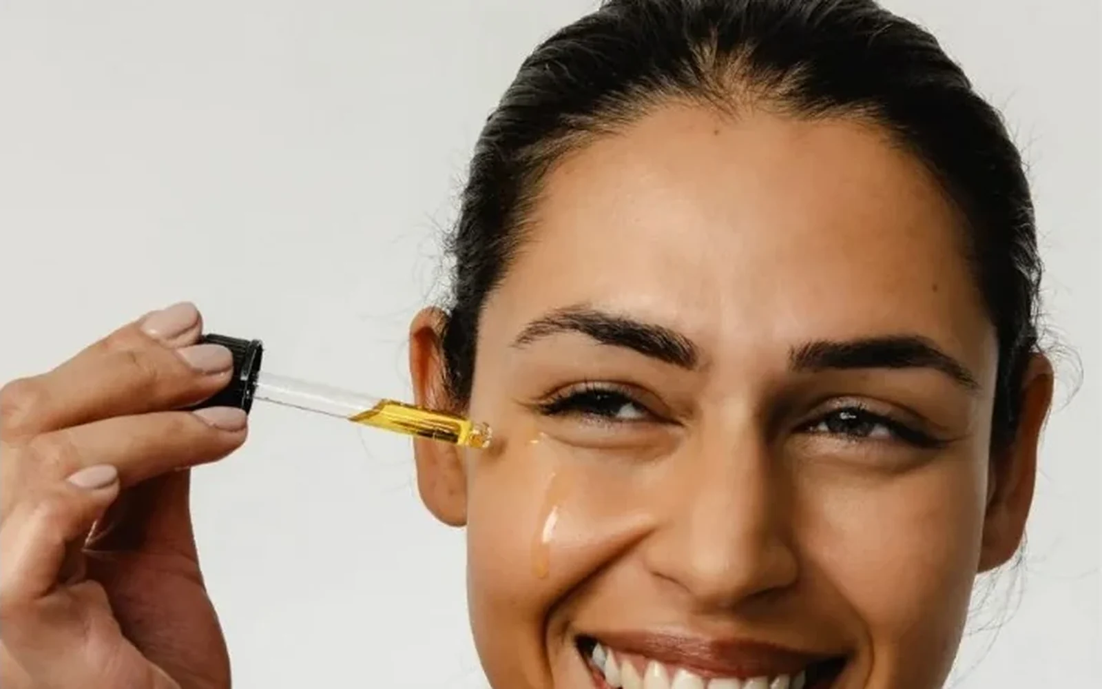 UpCircle With — a woman holding the face oil