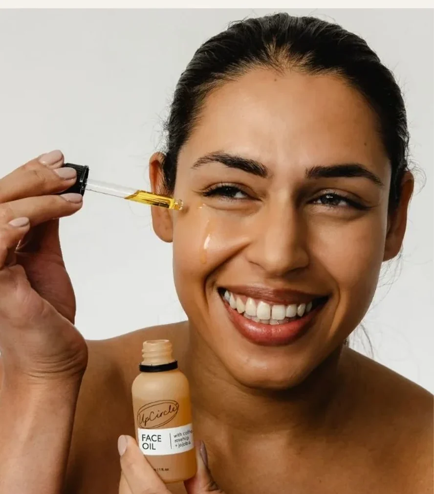 UpCircle With — a woman holding the face oil